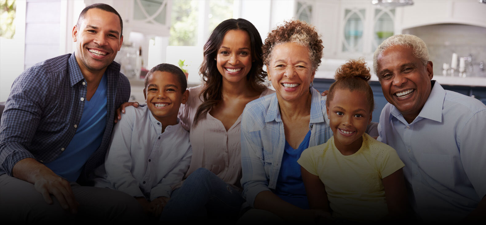 Family of 4 adults and 2 children smiling